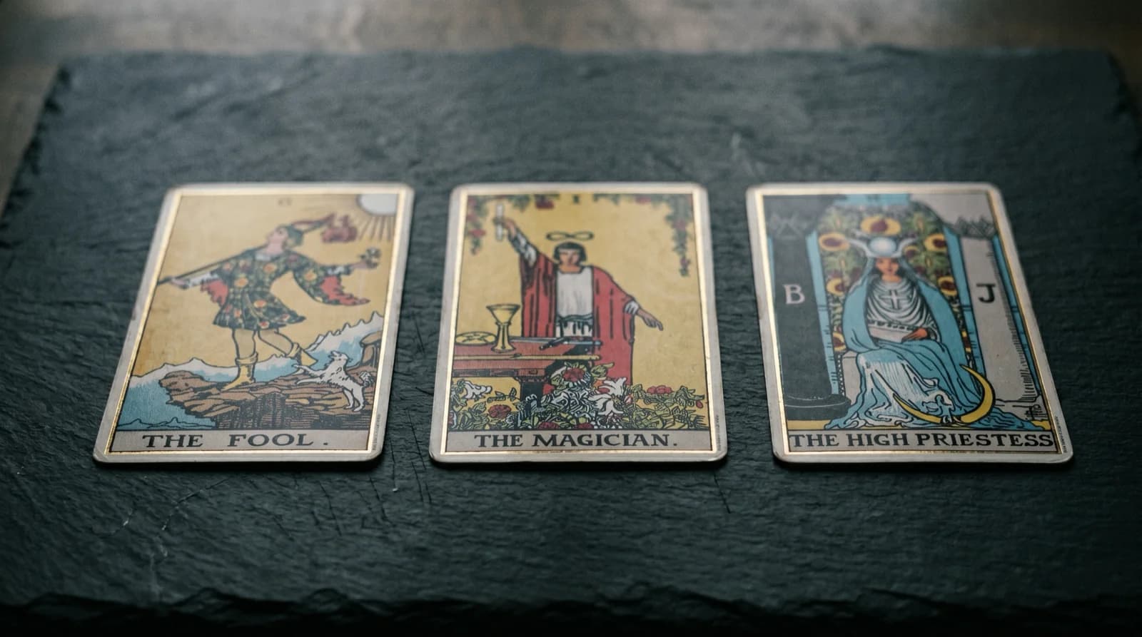 Detail of a gilded tarot card edge catching warm point light against muted parchment